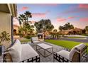 Inviting outdoor patio with cozy seating, a charming fireplace, and lush landscaping, ideal for relaxation and entertaining at 5670 W Linda Ln, Chandler, AZ 85226