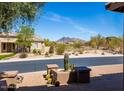 View of the neighborhood street with desert landscaping and the mountains visible in the background at 5709 E Sleepy Ranch Rd, Cave Creek, AZ 85331