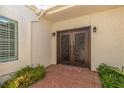 Close up of the impressive double front doors, framed by lush greenery and manicured landscaping at 5801 N 25Th Pl, Phoenix, AZ 85016