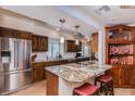 Gourmet kitchen features stainless steel appliances, granite countertops, and custom wood cabinetry at 5801 N 25Th Pl, Phoenix, AZ 85016