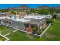 Enjoy the charming desert backyard with a covered patio, lush lawn, and mountain views at 5801 N 25Th Pl, Phoenix, AZ 85016