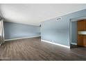 Spacious living room featuring hardwood floors, neutral paint, and ample natural light at 6938 E Flossmoor Ave, Mesa, AZ 85208