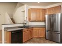 Modern kitchen with stainless steel appliances, including a refrigerator and sink at 8339 W Molly Ln, Peoria, AZ 85383