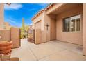 This home features an enclosed courtyard with a decorative metal gate, creating a cozy outdoor space at 8367 W Lariat Ln, Peoria, AZ 85383