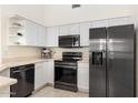 Modern kitchen featuring stainless steel appliances, ample storage, and sleek countertops at 9608 E Nacoma Dr, Sun Lakes, AZ 85248