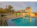 Inviting backyard featuring a refreshing pool and view of the home with desert landscaping in the background at 9834 N 1St St, Phoenix, AZ 85020