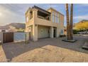 Two-story modern home with desert landscaping, balcony, tall windows, and accent lighting creating an inviting curb appeal at 9834 N 1St St, Phoenix, AZ 85020