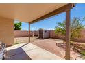 A covered patio with shade showcases the spacious backyard with a shed, lush greenery, and open space at 995 E Vernoa St, San Tan Valley, AZ 85140