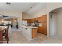 Spacious kitchen featuring an island, oak cabinets, and open floor plan at 995 E Vernoa St, San Tan Valley, AZ 85140