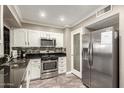 Well-maintained kitchen featuring stainless steel appliances, granite countertops, and modern cabinetry at 11122 W Desert Butte Dr, Sun City, AZ 85351