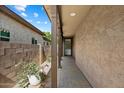 Covered walkway featuring neutral walls and flooring, creating an inviting entrance at 12114 W Desert Moon Way, Peoria, AZ 85383