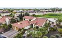 Gorgeous aerial view of a well-maintained home and yard near a golf course in a desert community at 15948 W Sheila Ln, Goodyear, AZ 85395