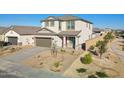 Striking two-story home showcasing a well-maintained front yard with decorative rock and an eye-catching red front door at 17642 W Sanna St, Waddell, AZ 85355