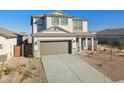 Beautiful exterior elevation with a large garage, desert landscaping, and modern architectural style at 17642 W Sanna St, Waddell, AZ 85355