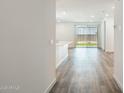 Hallway features wood-look floors and leads to the kitchen and outdoor space at 17825 W Mission Ln, Waddell, AZ 85355