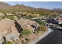 Aerial view of a home featuring a private driveway and a desert landscape at 18491 N 98Th Way, Scottsdale, AZ 85255