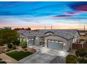 Charming home featuring a well-manicured lawn, mature landscaping, and a three-car garage with ample parking at 22372 E Duncan St, Queen Creek, AZ 85142