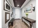 Inviting entryway with wood-look tile floors, a stylish console table, and tasteful decorative elements at 2336 W Magdalena Ln, Phoenix, AZ 85041