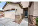 This home features a 2-car garage and attractive stone accents near the home's front entryway at 2336 W Magdalena Ln, Phoenix, AZ 85041
