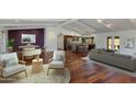 Open-concept living room with wood floors, beamed ceilings, and stylish furnishings at 302 E Carol Ann Way, Phoenix, AZ 85022