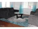 Cozy living room featuring comfortable seating, a stylish rug, and plenty of natural light at 303 S Recker Rd # 62, Mesa, AZ 85206
