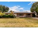 Charming single-story home featuring mature landscaping and a covered carport with a brick-accented facade at 4249 E Mitchell Dr, Phoenix, AZ 85018