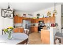Bright kitchen with stainless steel appliances, tile floors, wood cabinets, and a breakfast nook at 4945 E Shapinsay Dr, San Tan Valley, AZ 85140