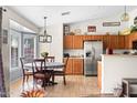 Bright kitchen with stainless steel appliances and a cozy breakfast nook with a round table and bay window at 4945 E Shapinsay Dr, San Tan Valley, AZ 85140
