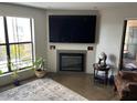 Living room with a modern fireplace, large tv, and comfortable seating area at 5110 N 31St Way # 345, Phoenix, AZ 85016