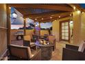 Outdoor area featuring a pergola, string lights, barbecue, dining table, and fire pit at 5431 W Cochise Dr, Glendale, AZ 85302