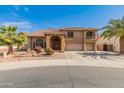 Stunning two-story home featuring a spacious three-car garage and mature palm trees enhancing the curb appeal at 5917 N 133Rd Ave, Litchfield Park, AZ 85340