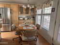 Bright dining area with a round table set for four, surrounded by natural light and attractive cabinetry at 650 N Hawes Rd # 4609, Mesa, AZ 85207