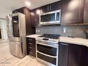 Well-equipped kitchen with stainless steel appliances, modern cabinets, and ample counter space at 7920 E Camelback Rd # 203, Scottsdale, AZ 85251