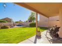 Covered patio area with landscaped backyard featuring a pool at 8637 W Kathleen Rd, Peoria, AZ 85382