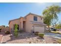 Well-maintained two-story home with a two-car garage, desert landscaping, and a welcoming entrance at 8637 W Kathleen Rd, Peoria, AZ 85382