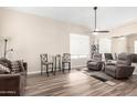 Cozy living room showcases wood-look floors, a ceiling fan, and comfortable seating at 8637 W Kathleen Rd, Peoria, AZ 85382