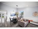 Open floor plan dining area with contemporary decor, adjacent seating, and bright natural light at 9818 W Pontiac Dr, Peoria, AZ 85382