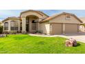 Well-maintained single-story home boasts a manicured lawn and an attached three-car garage at 11251 E Pratt Ave, Mesa, AZ 85212