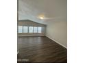 Spacious living room featuring luxury vinyl plank flooring and bright windows at 1143 S 96Th St, Mesa, AZ 85208