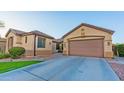 Single-story house with a well-manicured front lawn and a convenient two-car attached garage at 15430 W Sells Dr, Goodyear, AZ 85395