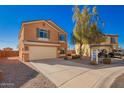 Two-story home boasting an attached 2-car garage, low-maintenance landscaping, and desert surroundings at 19084 N Toledo Ave, Maricopa, AZ 85138