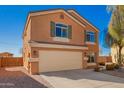 Charming two-story home featuring desert landscaping, a 2-car garage, and a well-kept exterior at 19084 N Toledo Ave, Maricopa, AZ 85138