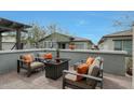 Cozy outdoor patio with comfortable seating, a fire pit table, and views of the neighborhood at 20721 W Fern Dr, Buckeye, AZ 85396