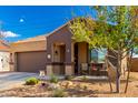 Beautifully landscaped home with a charming front porch and two-car garage at 23791 W Magnolia Dr, Buckeye, AZ 85326