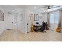 Well-lit home office with a ceiling fan, neutral walls, and a comfortable workspace at 24878 N 172Nd Dr, Surprise, AZ 85387