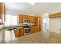 Modern kitchen featuring stainless steel appliances, granite countertops, and plenty of cabinet space for storage at 2550 E Taro Ln, Phoenix, AZ 85050