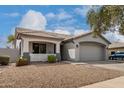 Beautiful single-story home with a large garage, tiled roof, desert landscaping, and a charming front porch at 3423 E Crescent Way, Gilbert, AZ 85298