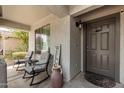 Inviting front porch with chairs and a 'Welcome' sign, creating a warm and friendly entrance at 3423 E Crescent Way, Gilbert, AZ 85298