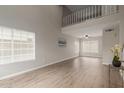 Bright living room boasting wood-look flooring, high ceilings, and large windows with views at 3630 W Camino Real --, Glendale, AZ 85310