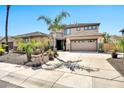 Gorgeous home with palm trees, desert landscaping, and long driveway leading to a three-car garage at 3925 E Vallejo Dr, Gilbert, AZ 85298